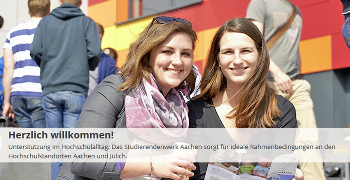 Aachen Student Services, two students reading a flyer look up to smile for the camera.Printed at the top of the picture are the sentences "Welcome. Support in everyday university life. Studierendenwerk aachen ensures ideal conditions at the university in Aachen and Jülich."
